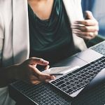 Woman on Laptop and Phone